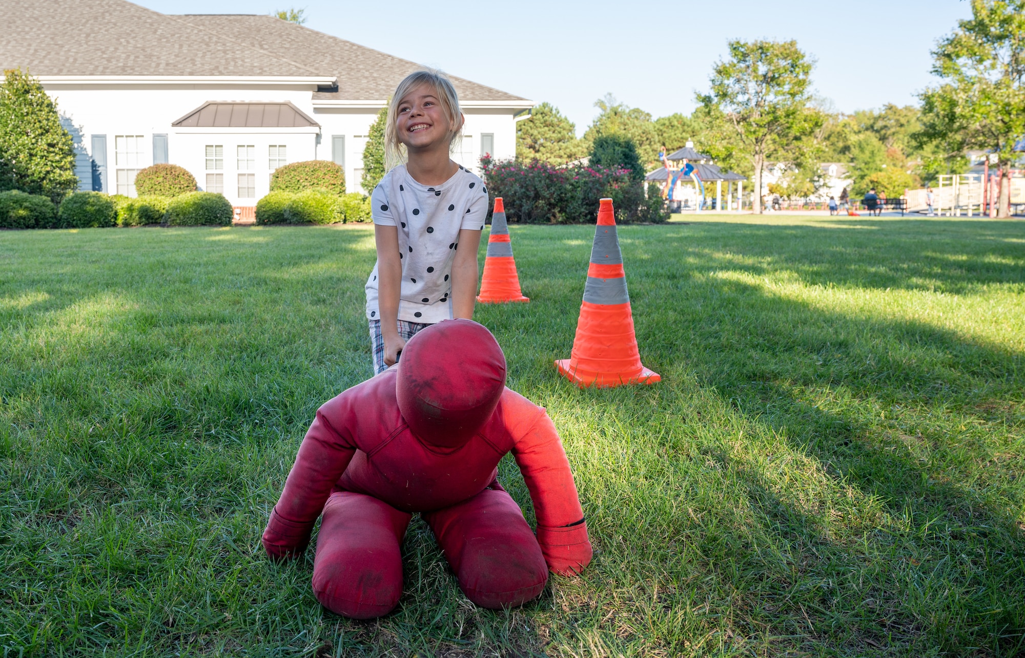 A child drags a simulated body