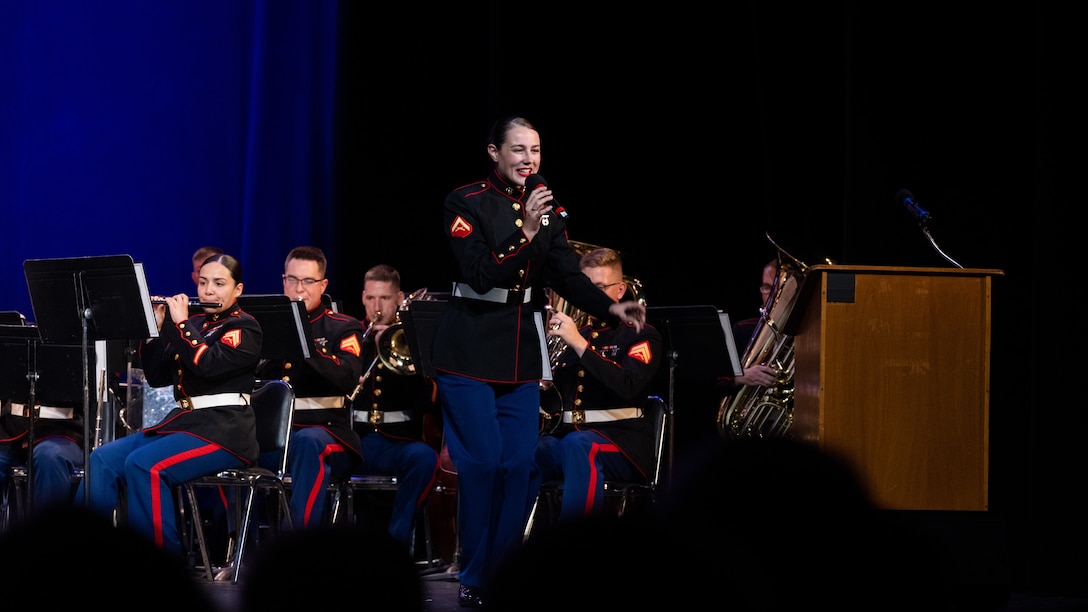 U.S. Marine Corps Lance Cpl. Elizabeth Marino, center, a vocalist with the 2nd Marine Aircraft Wing (MAW) Band, sings during the 34th Annual Vincent Vizzo Columbus Day Concert at Bridgeport, Connecticut, Oct. 6, 2023. Marines with the 2nd MAW Band performed during the 34th Annual Vincent Vizzo Columbus Day Concert to strengthen community relationships and reaffirm history, customs, and traditions representative of the United States Marine Corps to those in attendance. 2nd MAW is the aviation combat element of II Marine Expeditionary Force. (U.S. Marine Corps photo by Lance Cpl. Orlanys Diaz Figueroa)