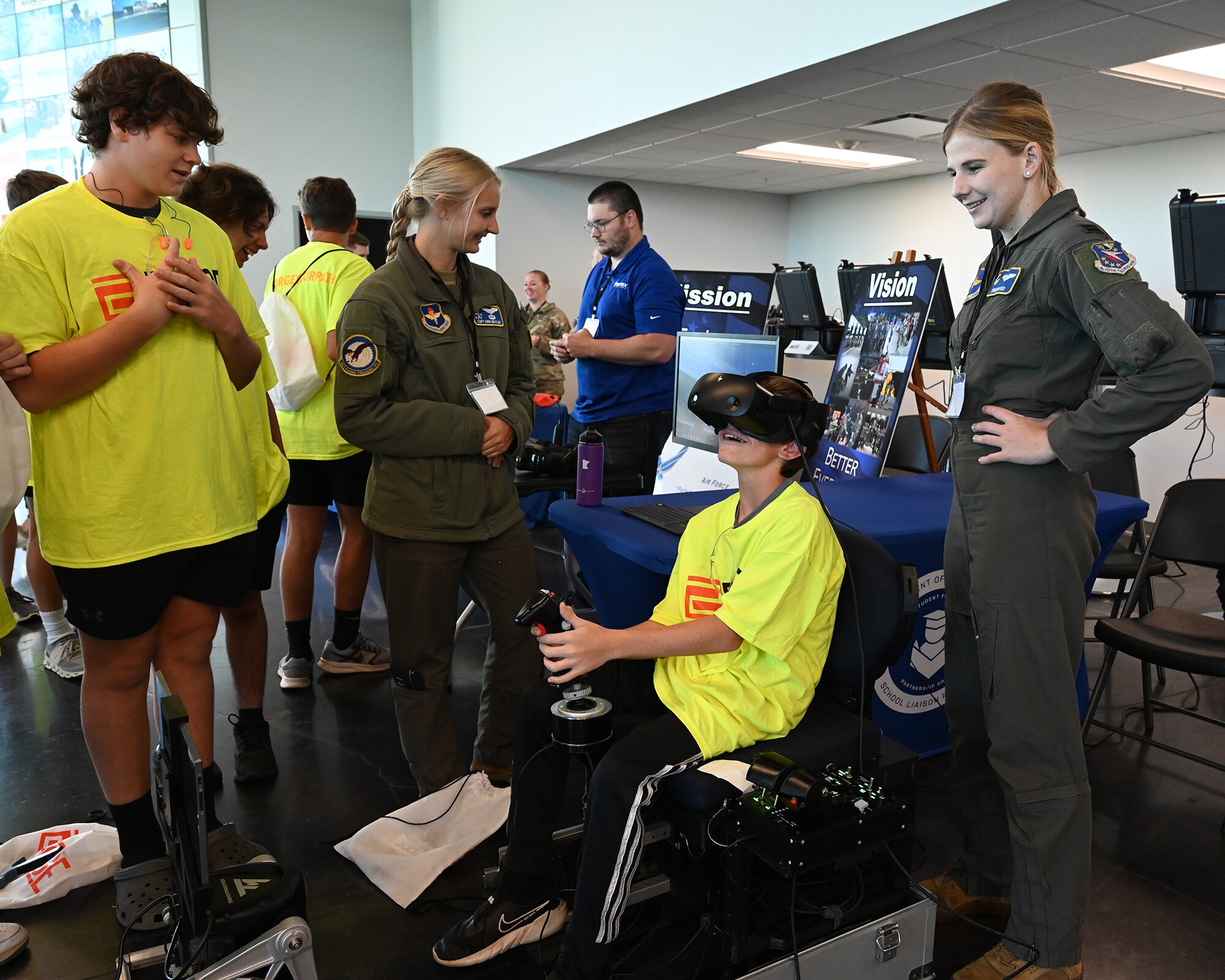 Pilots from Columbus Air Force Base instruct students from local counties on the operations of a virtual reality flying simulator at a FORGE career day event at East Mississippi Community College on October 25, 2023.