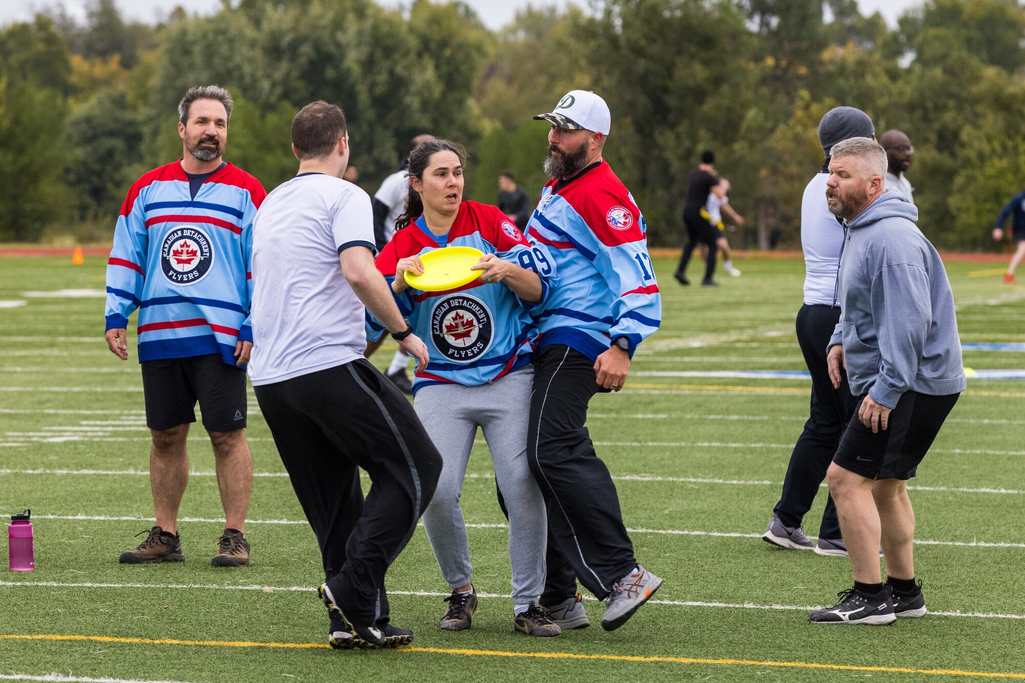 airmen playing frisbee