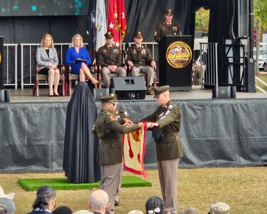 The Fort Eisenhower command team uncase the new Garrison Colors at the Fort Eisenhower redeisgnation ceremony Oct. 27, 2023.