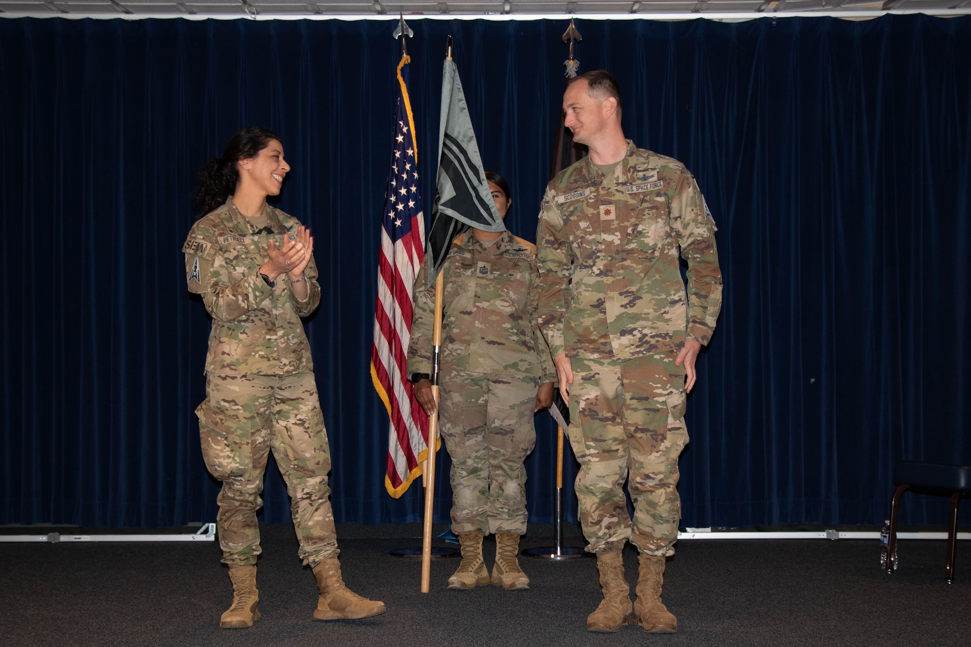 U.S. Space Force Col. Nicole Petrucci, commander of Space Delta 3 – Space Electromagnetic Warfare (left), applauds Maj. Zachary Scoggins, commander of the 23rd Electromagnetic Warfare Squadron (right), following the official activation of the 23rd EWS on Peterson Space Force Base, Colorado, Oct. 16, 2023. The 23rd EWS became the 5th squadron to fall under DEL 3. (U.S. Space Force photo by Emily Peacock)