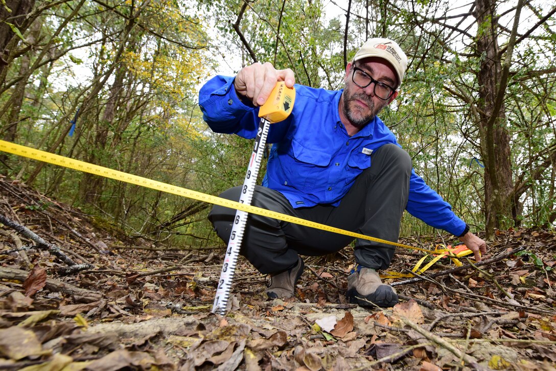 Ryan Evans, biologist in the Regulatory Division Technical Service Branch, takes measurements in a dry creek bed Oct. 24, 2023, near J. Percy Priest Lake to determine the volume of water that would flow through it. The Nashville District recently announced his selection as the July 2023 Employee of the Month. (USACE Photo by Lee Roberts)