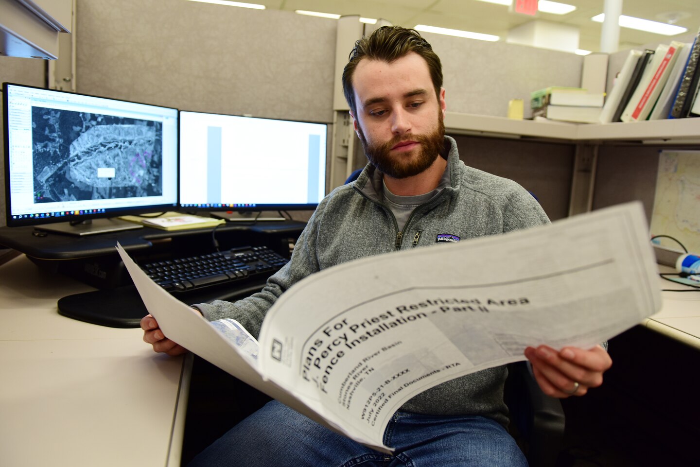 Jake Pierce, civil engineer in the Civil Site and Survey Section, works at his desk Oct. 24, 2023, at the U.S. Army Corps of Engineers Nashville District Headquarters in Nashville, Tennessee. The Nashville District recently announced his selection as the August 2023 Employee of the Month. (USACE Photo by Lee Roberts)