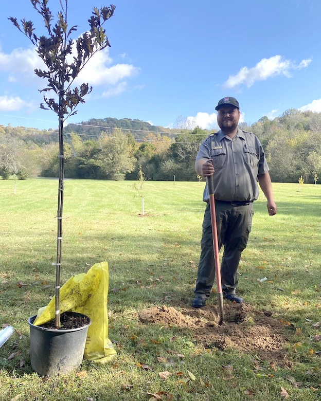 Park Ranger Hunter Humphrey plants a tree Oct. 20, 2023, on a six-acre plot of public land near the shoreline of Cordell Hull Lake in Gainesboro, Tennessee, for Tree Planting Day. (USACE Photo by Garrett Fagan)