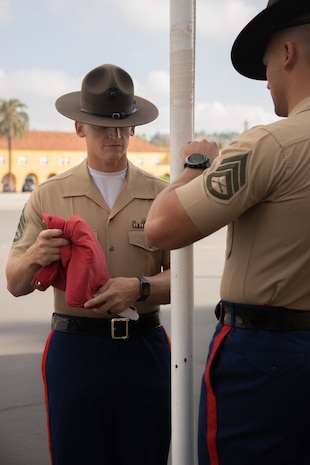 U.S. Marine Corps Staff Sgt. Garrett Schaefer, the drill master for 3rd Recruit Training Battalion, prepares to raise the flag during a graduation ceremony at Marine Corps Recruit Depot San Diego, Oct. 27, 2023. Graduation took place at the completion of the 13-week transformation, which included training for drill, marksmanship, basic combat skills, and Marine Corps customs and traditions. Schaefer  is native of Taylor, Texas. (U.S. Marine Corps photo by Lance Cpl. Janell B. Alvarez)