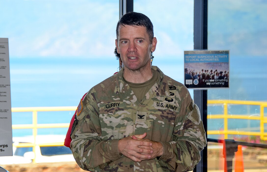 Army commander standing with graphic behind him