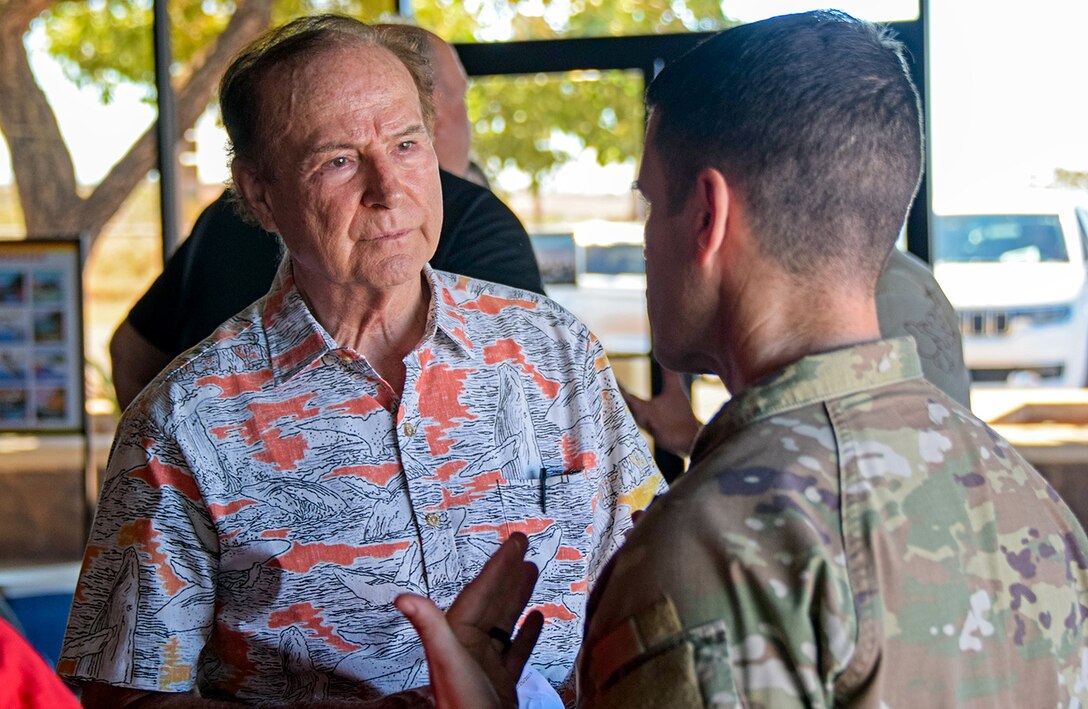 Army commander talks with government official.