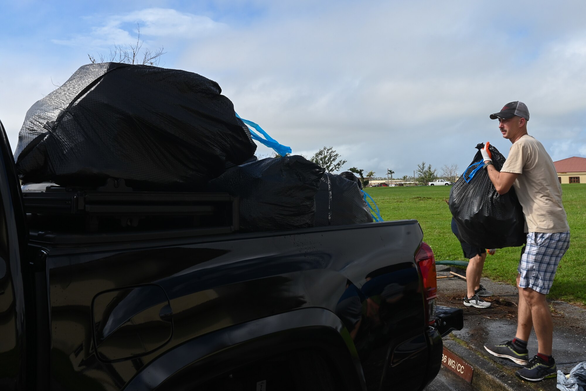 A U.S. Air Force Airman assigned to the 36th

Wing loads bags of debris from Typhoon

Mawar onto a truck at Andersen Air Force

Base, Guam, Oct. 25, 2023.