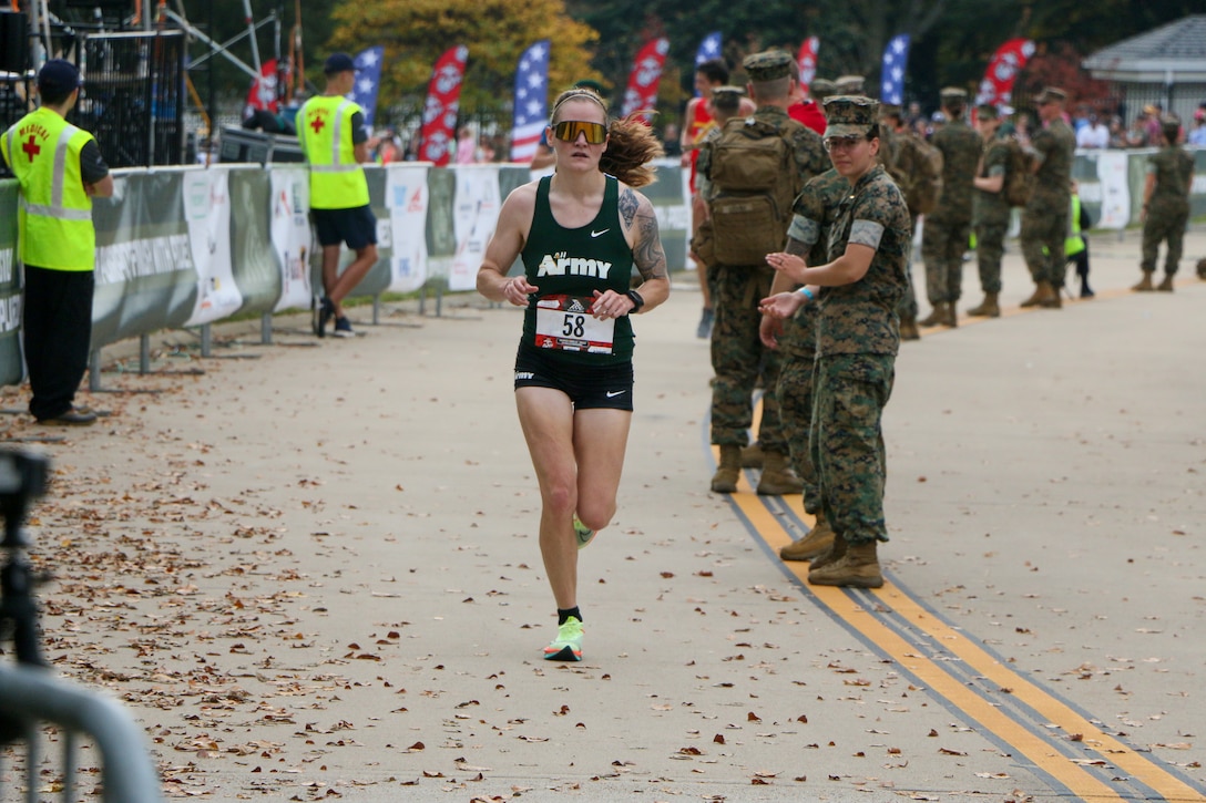 Army 1st. Lt. Kristen Gray of Fort Meade, Maryland crosses the finish line to win the women's division of the 2023 Armed Forces Marathon Championship held in conjunction with the 48th Marine Corps Marathon in Washington, D.C.  The Armed Forces Championship features teams from the Army, Marine Corps, Navy (with Coast Guard runners), and Air Force (with Space Force Runners).  Department of Defense Photo by Mr. Steven Dinote - Released.