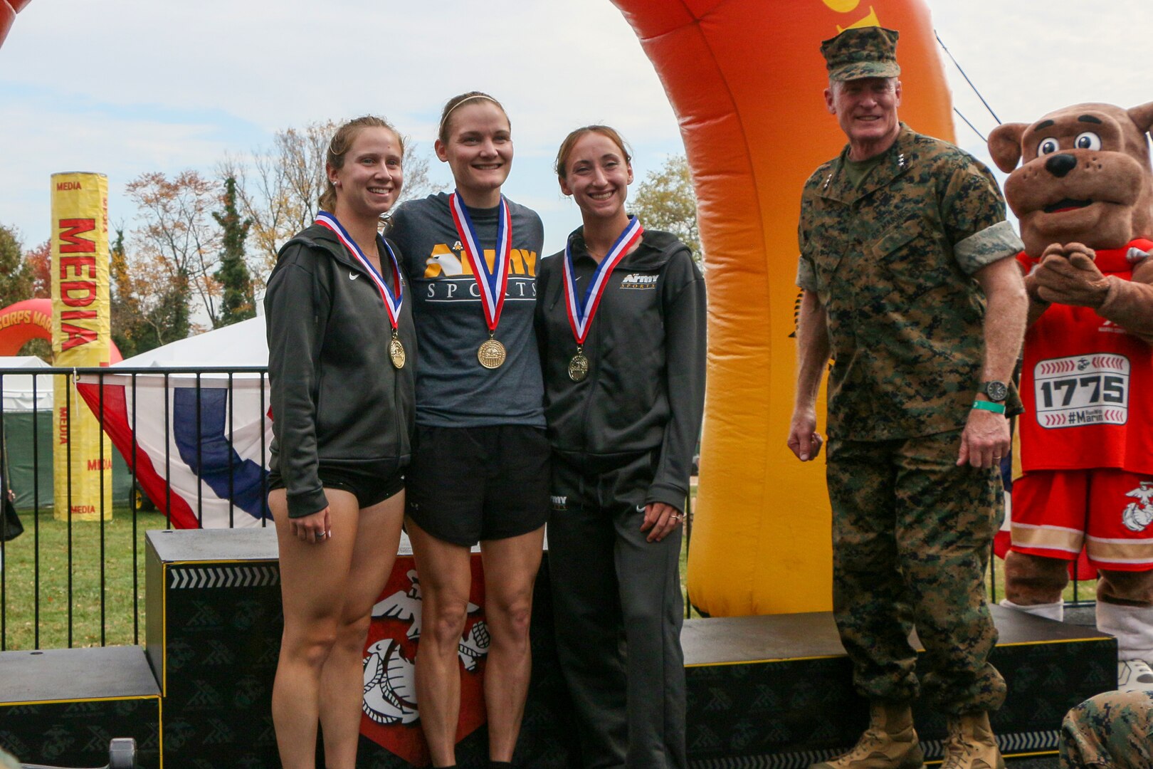 Army Women capture gold in the women's team competition of the 2023 Armed Forces Marathon Championship held in conjunction with the 48th Marine Corps Marathon in Washington, D.C.  The Armed Forces Championship features teams from the Army, Marine Corps, Navy (with Coast Guard runners), and Air Force (with Space Force Runners).  From left to right:  2nd Lt. Haley Seaward of Fort Leonard Wood, Mo.; 1st Lt. Krsten Gray of Fort Meade, Md. and 1st Lt. Samantha Collett of Fort Bliss, Texas, with Lt Gen Edward Banta (Deputy Commandant for Installations and Logistics).  Department of Defense Photo by Mr. Steven Dinote - Released.
