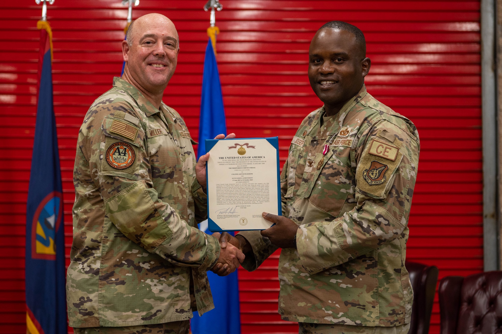 U.S. Air Force Col. Kenneth Joseph, outgoing commander of the 356th Expeditionary Civil Engineer Group, receives an award from Brig. Gen. Patrick G. Miller, director of logistics, engineering and force protection, headquarters Pacific Air Forces, Joint Base Pearl Harbor Hickam, Hawaii, at the Pacific Regional Training Center - Andersen, Guam, Oct. 20, 2023. Miller presided over the 356th ECEG change of command. (U.S. Air Force photo by Airman Allon Lapaix)