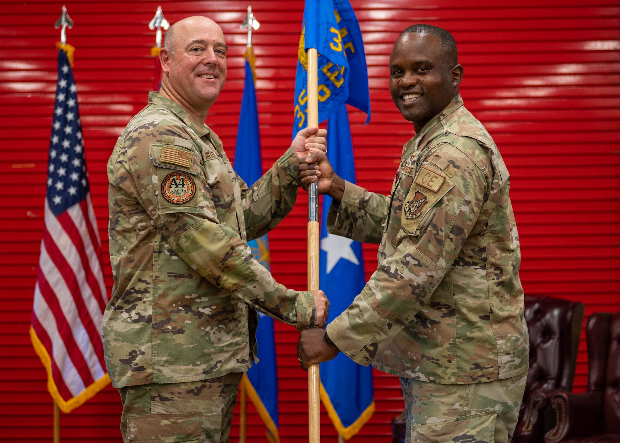 U.S. Air Force Col. Kenneth Joseph gives the guidon to Brig. Gen. Patrick G. Miller, director of logistics, engineering and force protection, headquarters Pacific Air Forces, Joint Base Pearl Harbor Hickam, Hawaii, at the Pacific Regional Training Center - Andersen, Guam, Oct. 20, 2023. Joseph held the position of commander for the past two years. (U.S. Air Force photo by Airman Allon Lapaix)