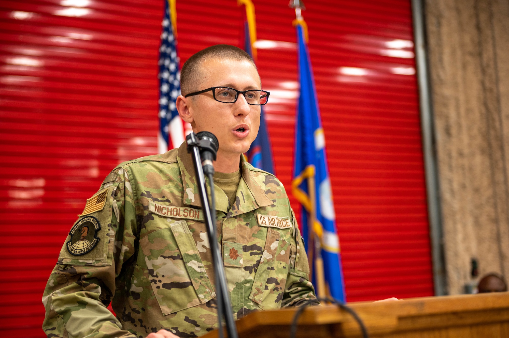 U.S. Air Force Maj. Chrystopher Nicholson, commander of the 513th Rapid Engineer Deployable Heavy Operations Repair Squadron Engineers Squadron, gives a speech after assuming command at the Pacific Regional Training Center – Andersen, Guam, Oct. 20, 2023. Nicholson is now responsible for leading the RHS. (U.S. Air Force photo by Airman Allon Lapaix)