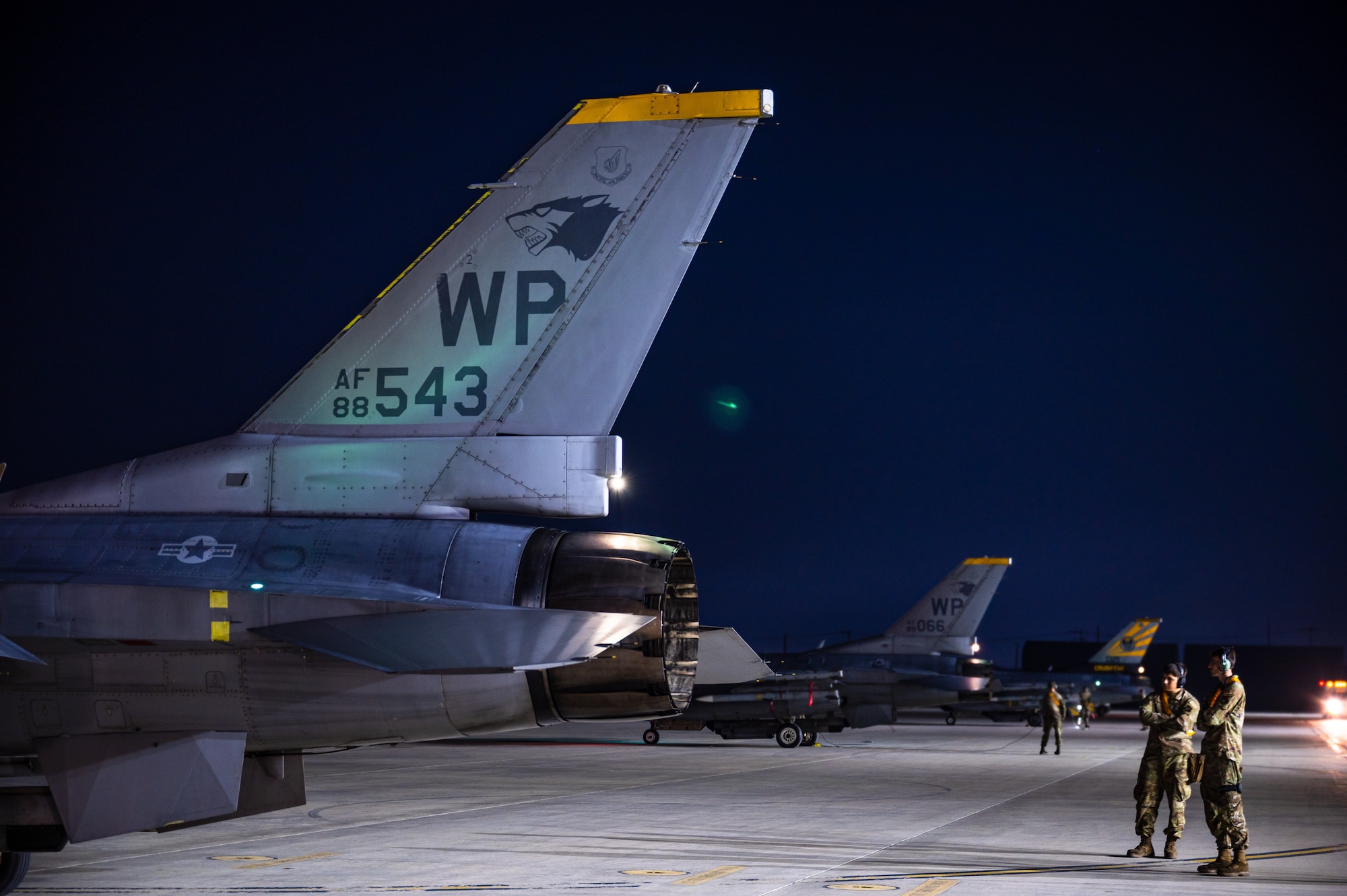 80th Fighter Generation Squadron Airmen observe an F-16 Fighting Falcon while conducting preflight systems inspections.