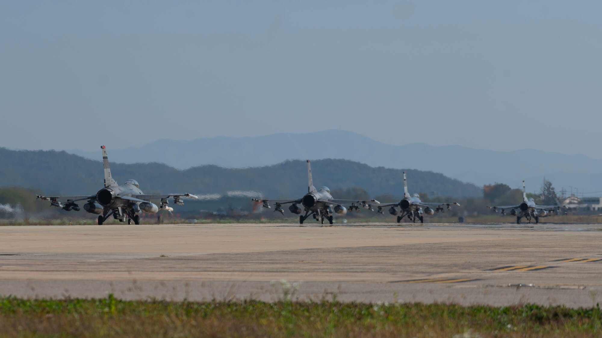 F-16 Fighting Falcons from the 36th Fighter Squadron, taxi the runway during Vigilant Defense 24 at Osan Air Base, Republic of Korea, Oct. 29, 2023. The aircraft generation demonstrated the 51st Fighter Wing’s rapid generation capabilities and response readiness, ensuring the wing remains ready to “Fight Tonight”. VD24 is a routine training event that tests the military capabilities across the peninsula, allowing combined and joint training at both the operational and tactical levels. (U.S. Air Force photo by Staff Sgt. Aubree Owens)