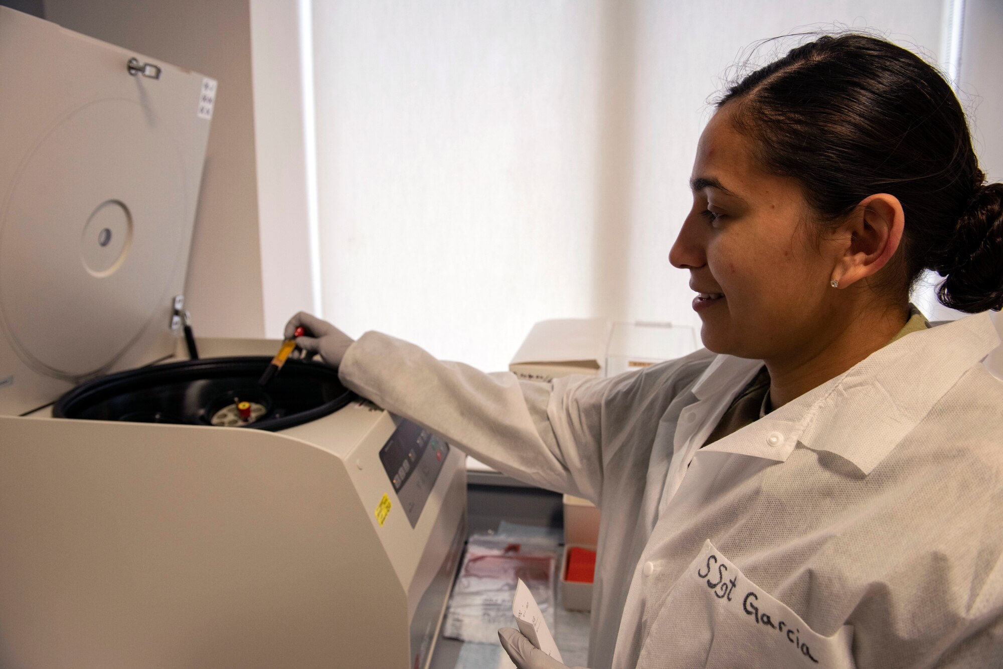 Staff Sgt. Gisele Garcia, 423d Medical Squadron medical laboratory technician, places a blood sample into a centrifuge at RAF Alconbury,
