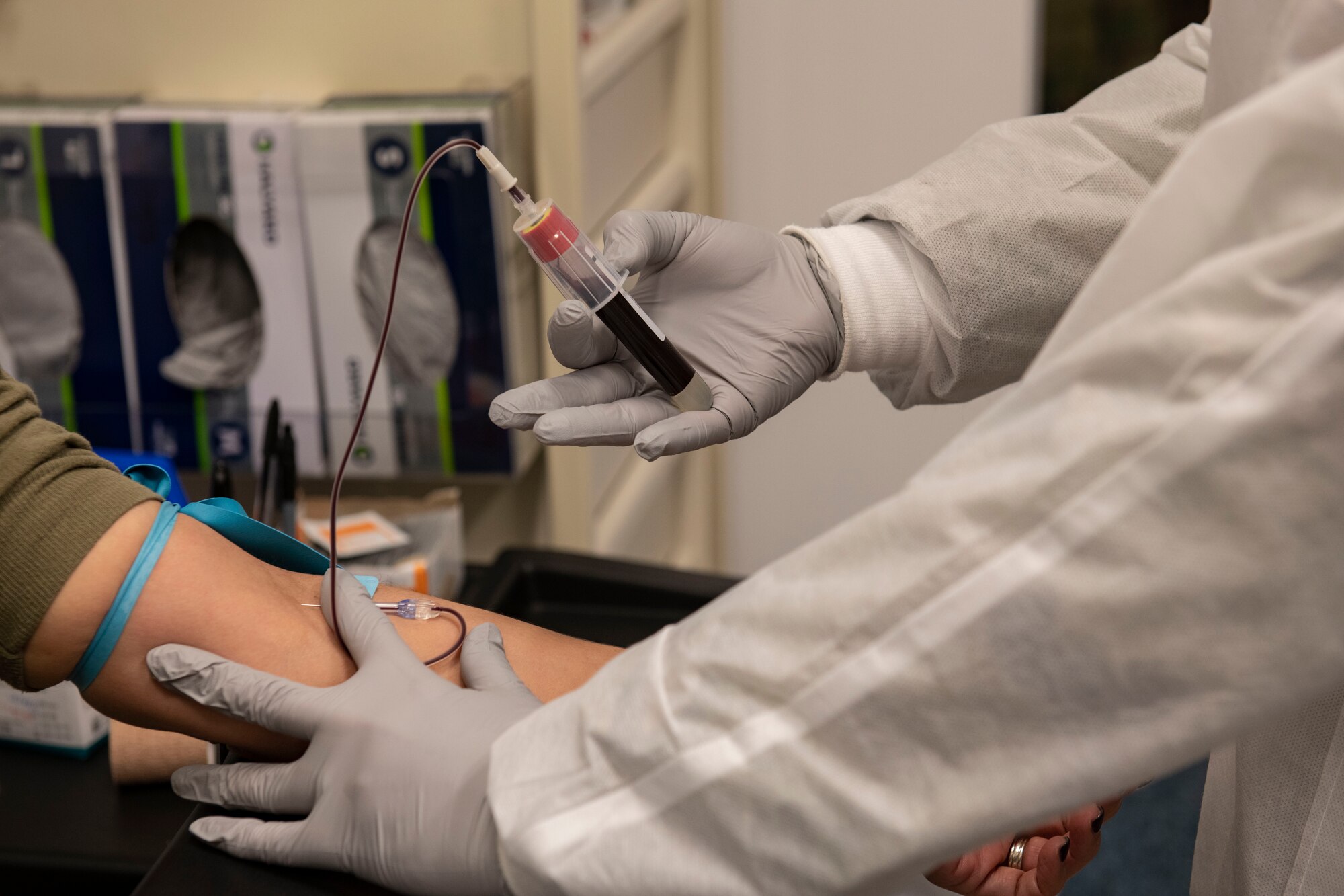 Staff Sgt. Gisele Garcia, 423d Medical Squadron medical laboratory technician, right, draws blood from Master Sgt. Yara Hernandez, 501st Combat Support Wing executive services superintendent, at RAF Alconbury