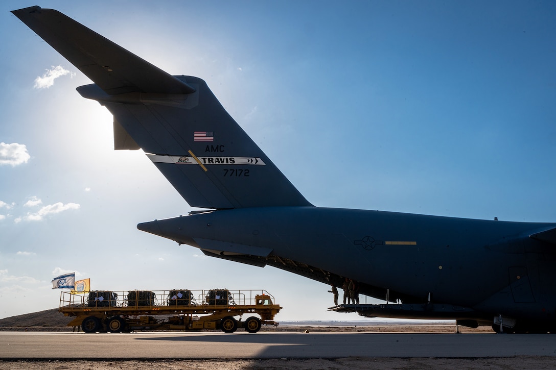 Airmen offload cargo from a military aircraft.