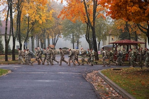 Soldiers walk across a road during a joint training exercise.