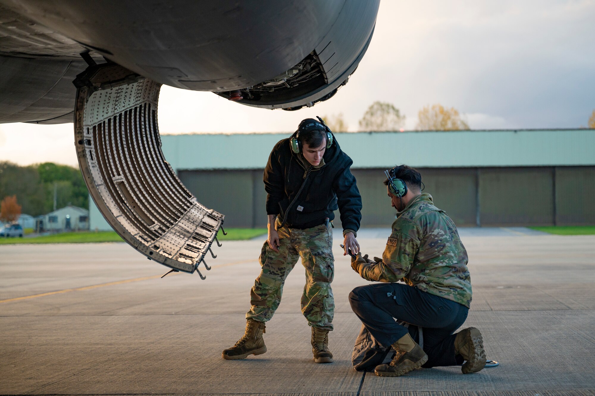 Staff Sgt. Thomas Marbut and Staff Sgt. Michael Souquette, 9th Expeditionary Bomb Squadron deployed engine managers perform routine maintenance on a B-1B Lancer at RAF Fairford, United Kingdom, Oct. 30, 2023. Hot pit refueling capabilities showcase innovation and mission readiness by allowing the aircraft to refuel without stopping their engines. (U.S. Air Force photo by Airman 1st Class Emma Anderson)