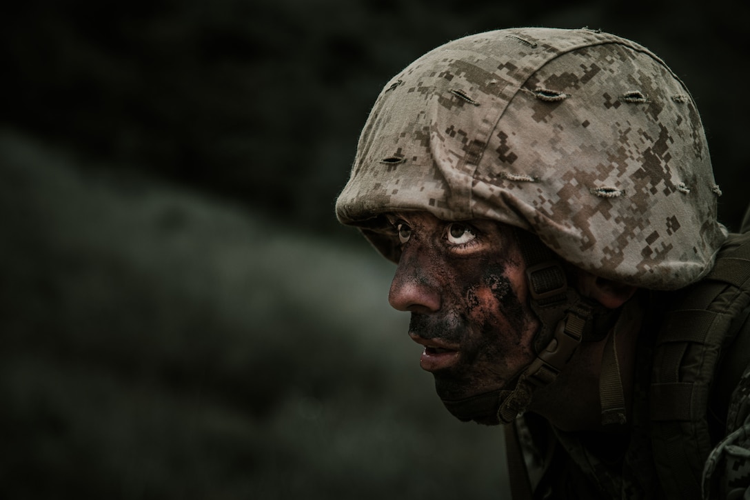 Close-up of a uniformed Marine recruit wearing face paint.