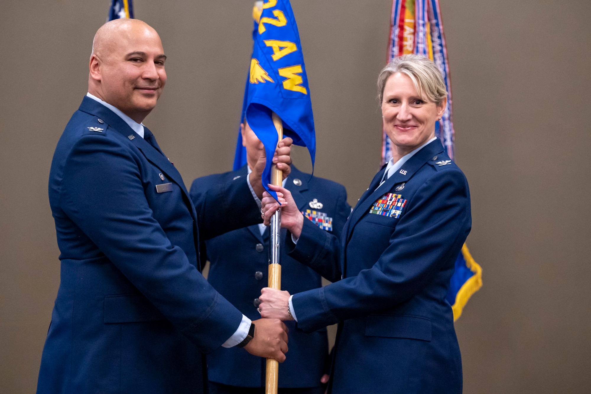 Col. Jeffrey Smith, 932nd Airlift Wing commander, posses with Col. Dori Mansur, 932nd Mission Support Group commander, during Mansur's  Assumption of Command ceremony, Oct. 14th, 2023, Scott Air Force Base, Illinois. (U.S. Air Force photo by Senior Airman Jonathan Stefanko)