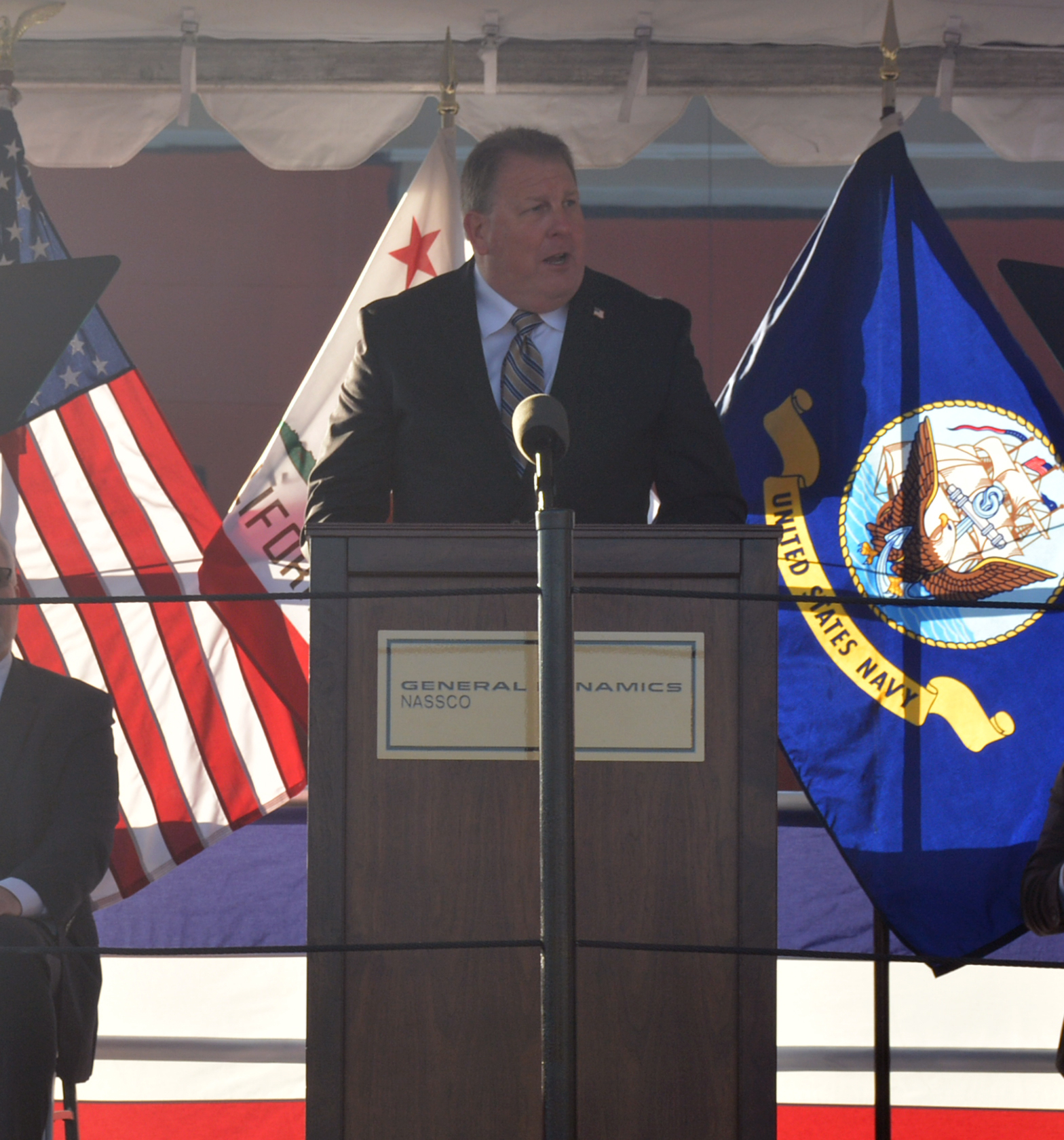 Steven Cade, Executive Director, Military Sealift Command, addresses the audience at the christening ceremony for MSC's newest ship USNS Robert F. Kennedy (T-AO 208) at the General Dynamics NASSCO shipyard in San Diego, Calif.