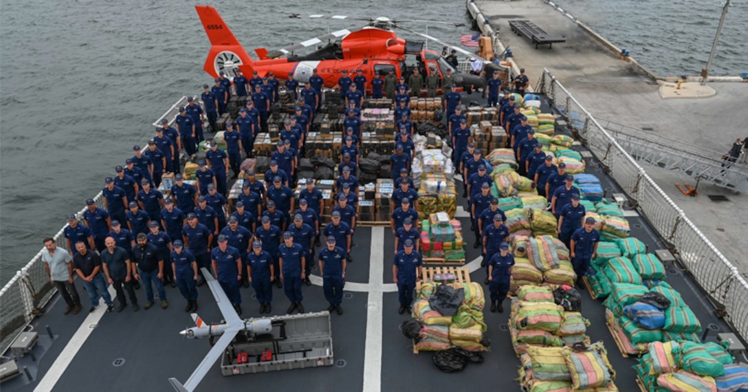 The crew of the Coast Guard Cutter James pose with more than $445 million in illegal drugs.
