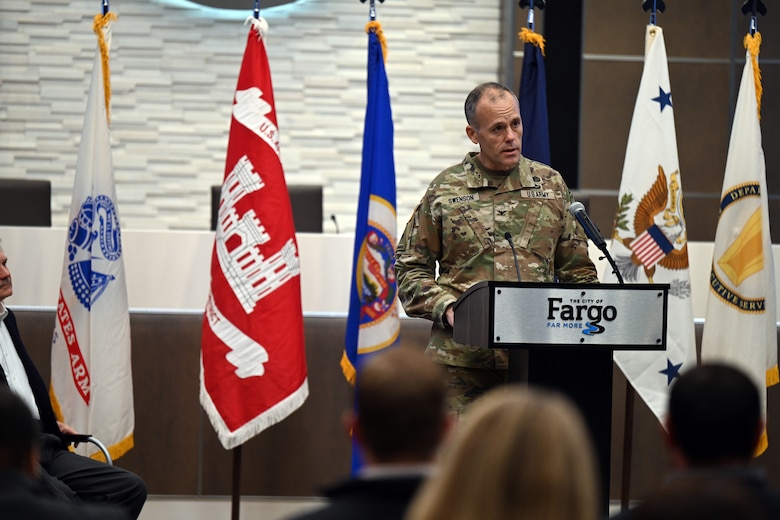 Col. Eric Swenson speaks at a podium