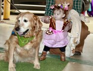 Little reindeer 9-month-old Renee Bauer pets Dinah, the Lutheran Church Charity Comfort Dog, during the Illinois National Guard Family Programs "Trunk or Treat" on Oct. 28 on Camp Lincoln in Springfield, Illinois. The Illinois National Guard is also holding a Trunk or Treat for military families on Sunday, Oct. 29, 1-4 p.m., at the North Riverside Armory, 8660 W. Cermak Road, North Riverside, Illinois. The Trunk or Treat is a family and pet-friendly event open to servicemembers, veterans and their families throughout Chicagoland area. There will be costume contests with prizes for adults, children, and pets.