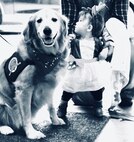 Dinah, the Lutheran Church Charity Comfort Dog from the Trinity Lutheran Church in Auburn, Illinois, enjoys the attention of little reindeer 9-month-old Renee Bauer during the Illinois National Guard Family Programs "Trunk or Treat" on Oct. 28 on Camp Lincoln in Springfield, Illinois. The Illinois National Guard is also holding a Trunk or Treat for military families on Sunday, Oct. 29, 1-4 p.m., at the North Riverside Armory, 8660 W. Cermak Road, North Riverside, Illinois. The Trunk or Treat is a family and pet-friendly event open to servicemembers, veterans and their families throughout Chicagoland area. There will be costume contests with prizes for adults, children, and pets.