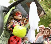 Four-year-old Sophia Bennett reaches up to touch the face of a ghost during the Illinois National Guard Family Programs "Trunk or Treat" on Oct. 28 on Camp Lincoln in Springfield, Illinois. The Illinois National Guard is also holding a Trunk or Treat for military families on Sunday, Oct. 29, 1-4 p.m., at the North Riverside Armory, 8660 W. Cermak Road, North Riverside, Illinois. The Trunk or Treat is a family and pet-friendly event open to servicemembers, veterans and their families throughout Chicagoland area. There will be costume contests with prizes for adults, children, and pets.