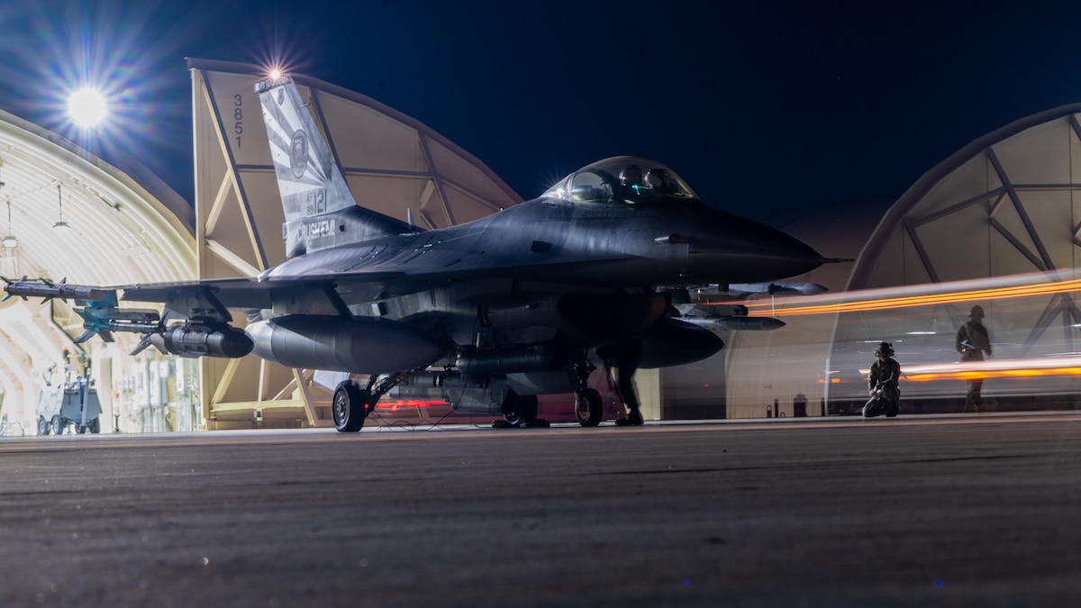 80th Fighter Generation Squadron Airmen observe an F-16 Fighting Falcon while conducting preflight systems inspections.