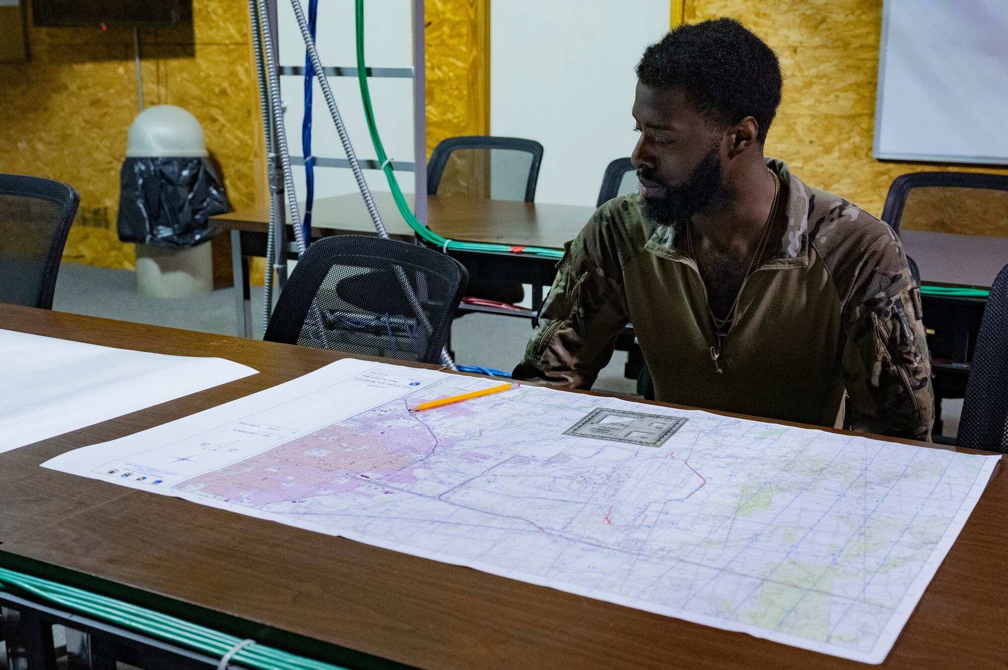 U.S. Air Force Senior Airman Jermaine Williams, 7th Security Forces Squadron defender, analyzes a map during the map reading section of the Expert Defender competition at Dyess Air Force Base, Texas, Oct. 25, 2023. The competition tested the defenders’ weapons proficiency, physical fitness and radio procedures. (U.S. Air Force photo by Airman 1st Class Alondra Cristobal Hernandez)