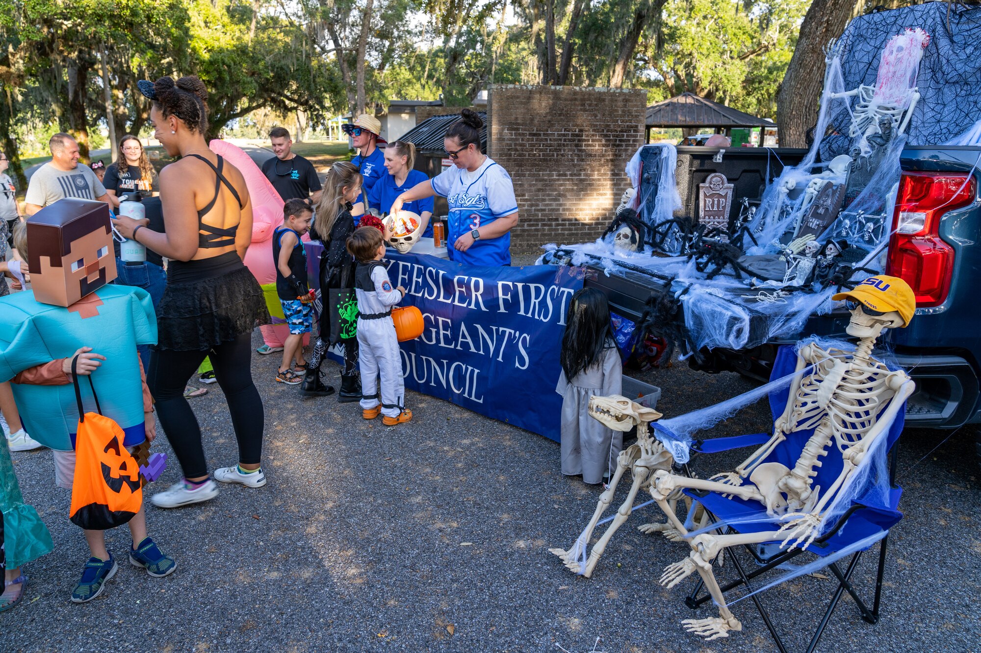 U.S. Airmen and their families go trunk or treating during Ghouls in the Park at Keesler Air Force Base, Mississippi, Oct. 27, 2023.