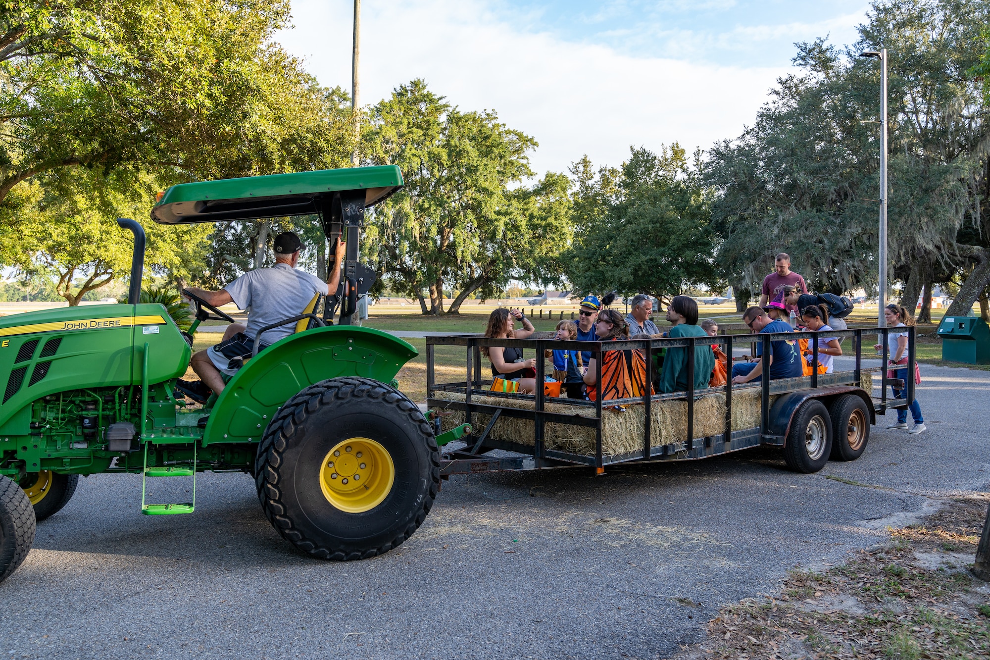 U.S. Airmen and their families go on a hay ride during Ghouls in the Park at Keesler Air Force Base, Mississippi, Oct. 27, 2023.