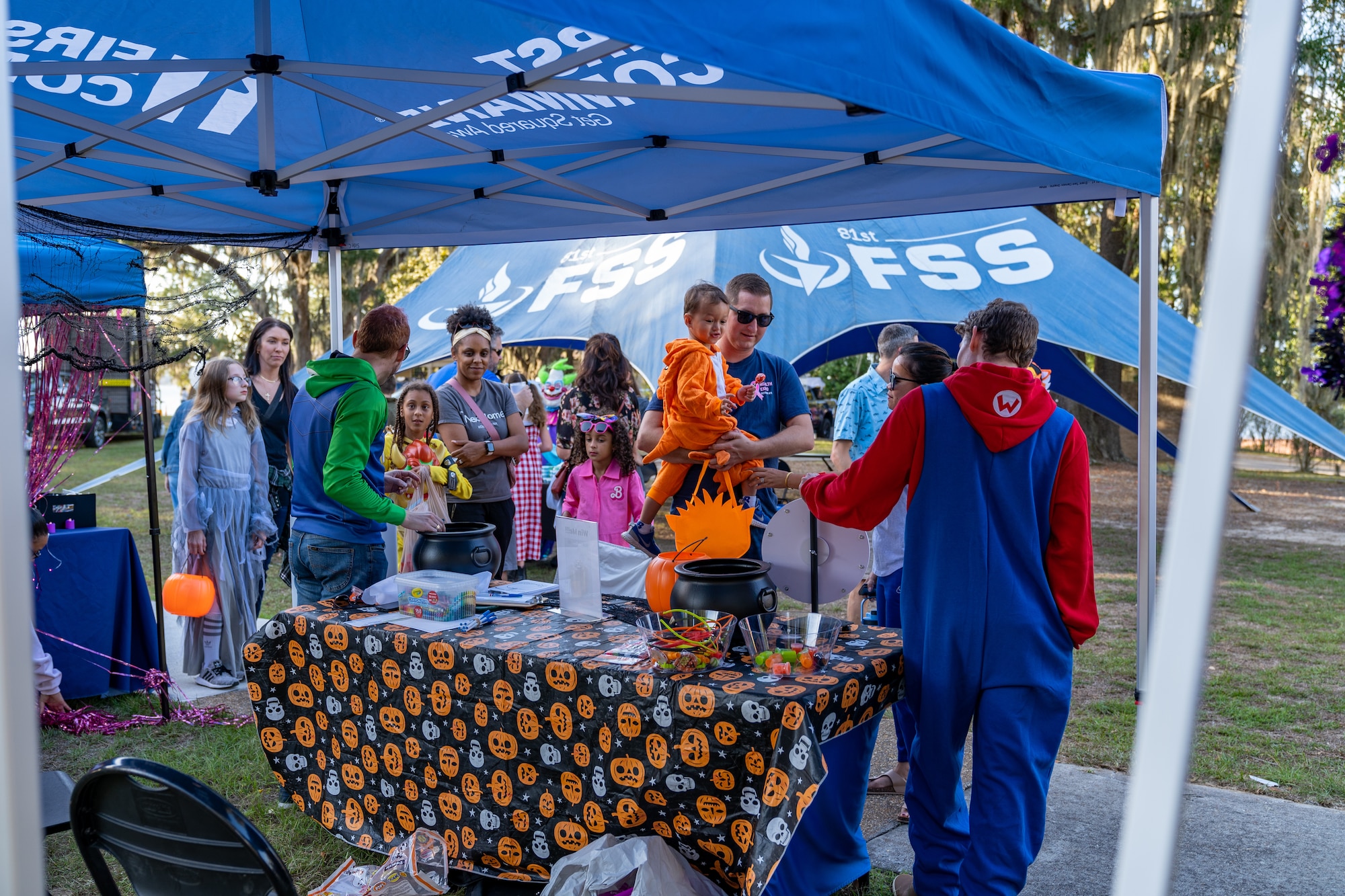 U.S. Airmen and their families go trick or treating during Ghouls in the Park at Keesler Air Force Base, Mississippi, Oct. 27, 2023.