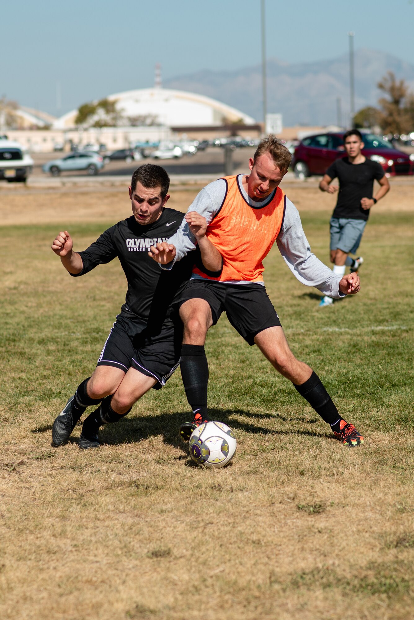 two soccer players compete to control the ball