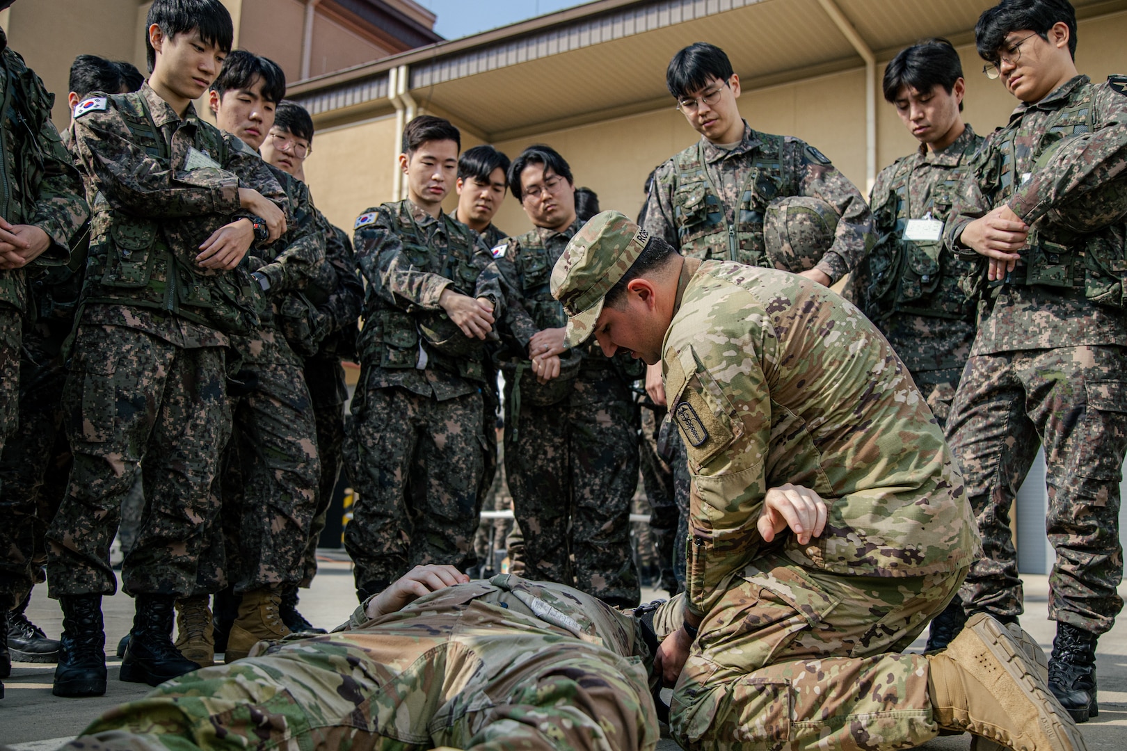 A Soldier from the 65th Medical Brigade instructs Korean Augmentation to the U.S. Army reserve Soldiers on first aid procedures during a joint mobilization training event at U.S. Army Garrison Humphreys, South Korea, Oct. 25, 2023. About 700 KATUSA Soldiers descended on Camp Humphreys to conduct their three-day mobilization training. It was the first time they conducted this training on a U.S. Army base in South Korea. (U.S. Army photo by Cpl. Choi, Kang Min)
