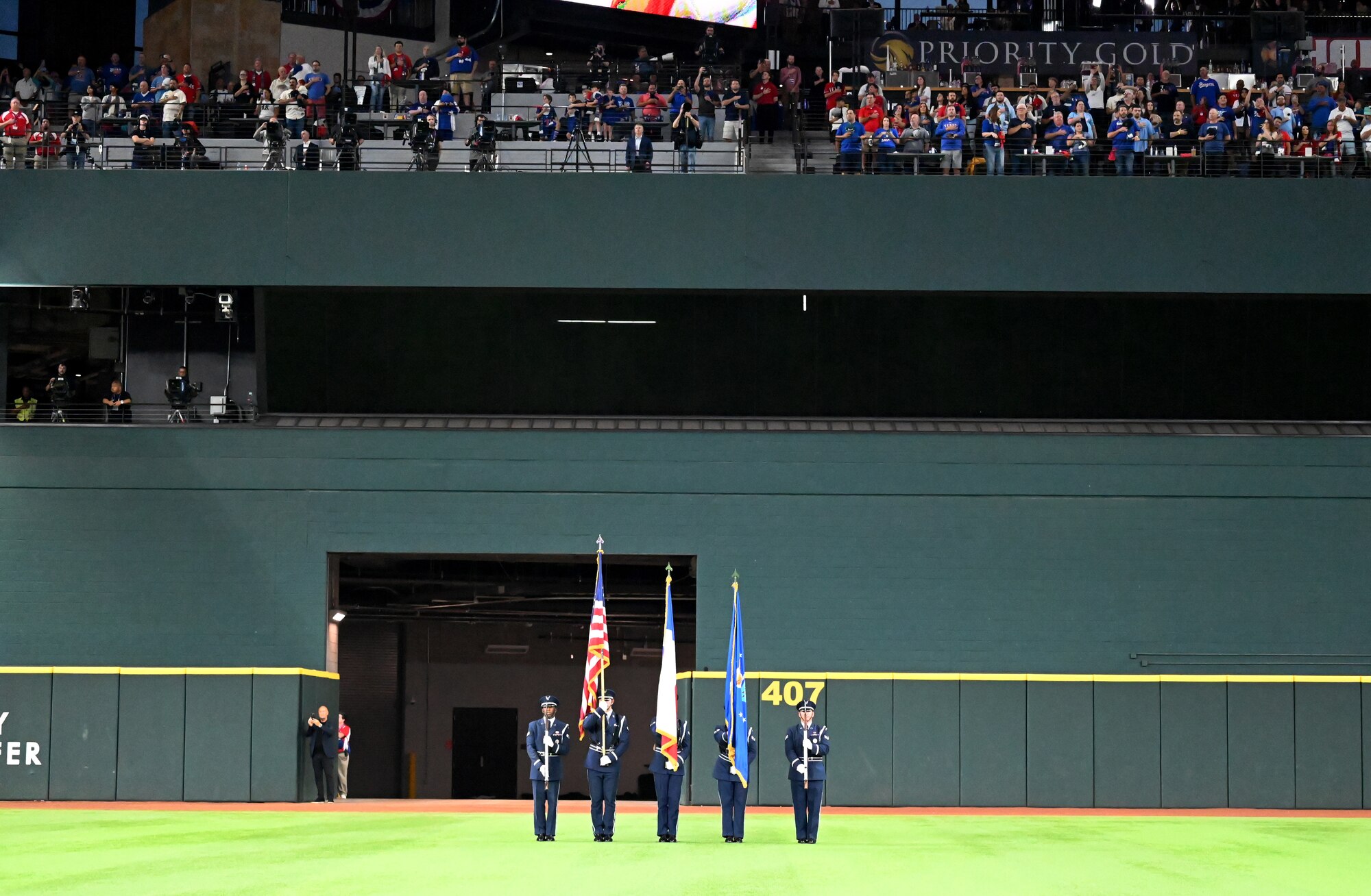 The Dyess Honor Guard presents the colors during the national anthem at the World Series opening game at Globe Life Field in Arlington, Texas, Oct. 27, 2023. The honor guard presented the U.S., Texas and Air Force flags to more than 40,300 attendees showcasing the Air Force Honor Guard mission of delivering ceremonial honors to inspire the nation. (U.S. Air Force photo by Staff Sgt. Holly Cook)