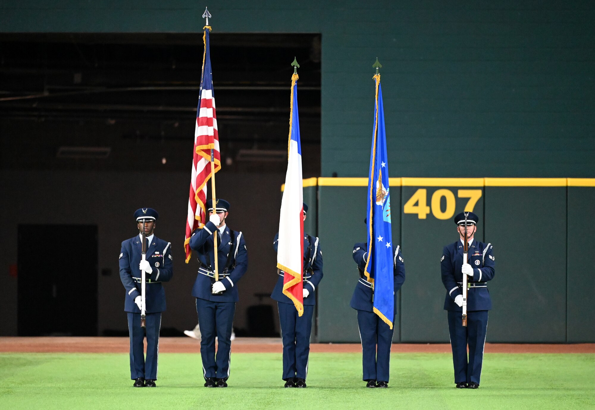 The Dyess Honor Guard presents the colors during the national anthem at the World Series opening game at Globe Life Field in Arlington, Texas, Oct. 27, 2023. The Dyess Honor Guard provides services including funeral honors and presenting the colors at ceremonies, parades and sporting events. (U.S. Air Force photo by Staff Sgt. Holly Cook)