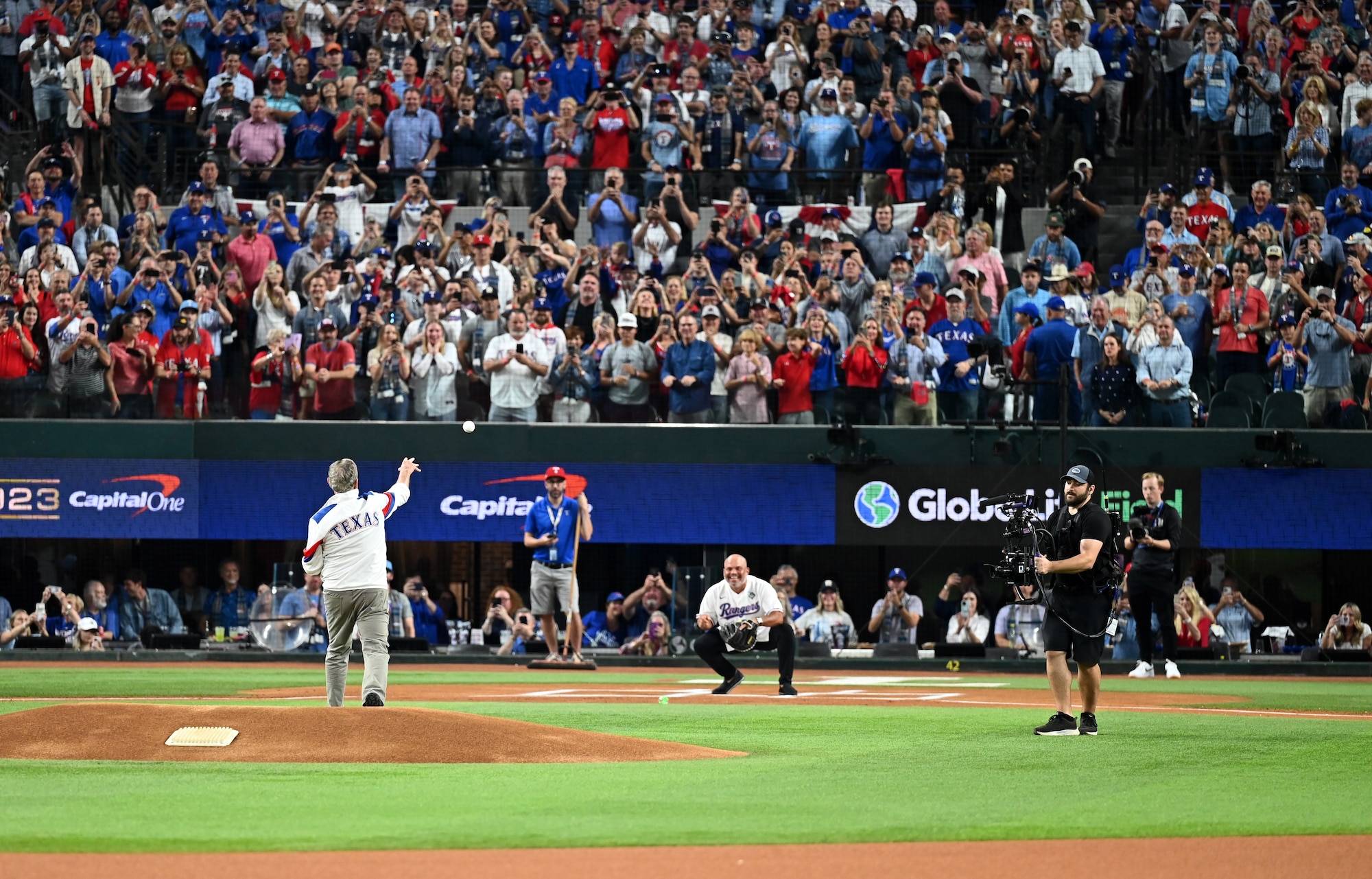 Former President George W. Bush throws the first pitch to Pudge Rodriguez, Baseball Hall of Fame member and former Texas Ranger, during the pre-game ceremony at the World Series opening game at Globe Life Field in Arlington, Texas, Oct. 27, 2023. The presidential first pitch is a baseball tradition dating back to former President William Howard Taft throwing the first pitch at the Washington Senator’s opening day game at Griffith Stadium in 1910. (U.S. Air Force photo by Staff Sgt. Holly Cook)