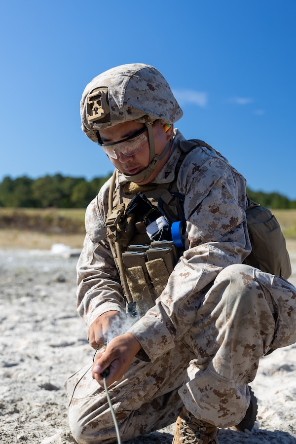 U.S. Marine Corps Lance Cpl. Paing Win, an engineer assistant with Marine Wing Support Squadron (MWSS) 271, primes an explosive during Field Exercise (FEX) 1-24 at Marine Corps Base Camp Lejeune, North Carolina, Oct. 24, 2023. Combat engineers with MWSS-271 trained in clearing, breaching, and airfield-recovery operations using distributed aviation operations and distributed command-and-control tactics during FEX 1-24. MWSS-271 is a subordinate unit of 2nd Marine Aircraft Wing, the aviation combat element of II Marine Expeditionary Force. (U.S. Marine Corps photo by Cpl. Adam Henke)