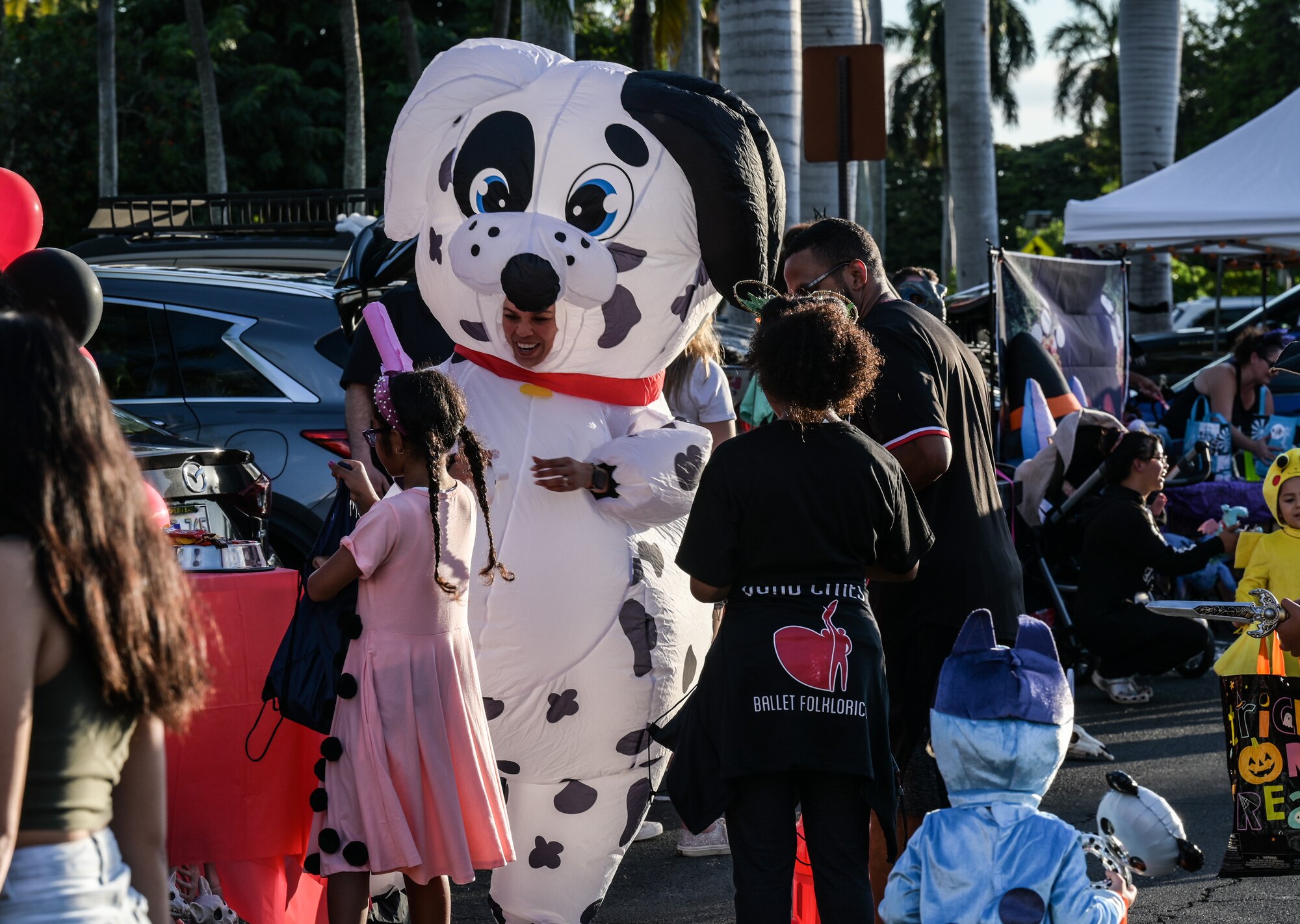 Volunteers and trick-or-treaters attend a 15th Wing Trunk-or-Treat event at Joint Base Pearl Harbor-Hickam, Hawaii, Oct. 27, 2023. Trunk-or-Treat is an event that offers trick-or-treating down a row of decorated vehicles for families to walk through and receive candy. (U.S. Air Force photo by Staff Sgt. Alan Ricker)
