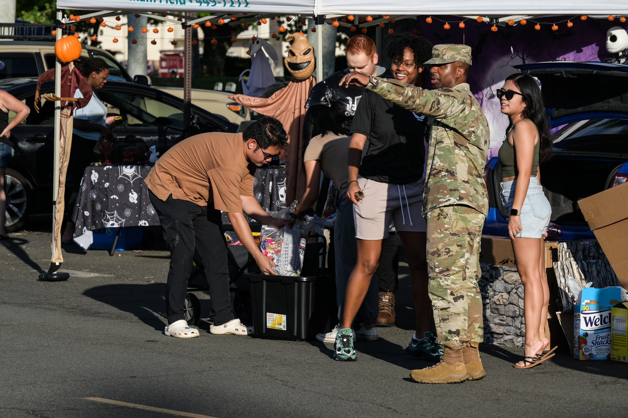 Chief Master Sgt. Anthony Thompson Jr., 15th Wing command chief, speaks to volunteers during a 15th Wing Trunk-or-Treat event at Joint Base Pearl Harbor-Hickam, Hawaii, Oct. 27, 2023. The event provided a safe and fun way for children of the military and civilian employees to trick or treat. (U.S. Air Force photo by Senior Airman Alan Ricker)