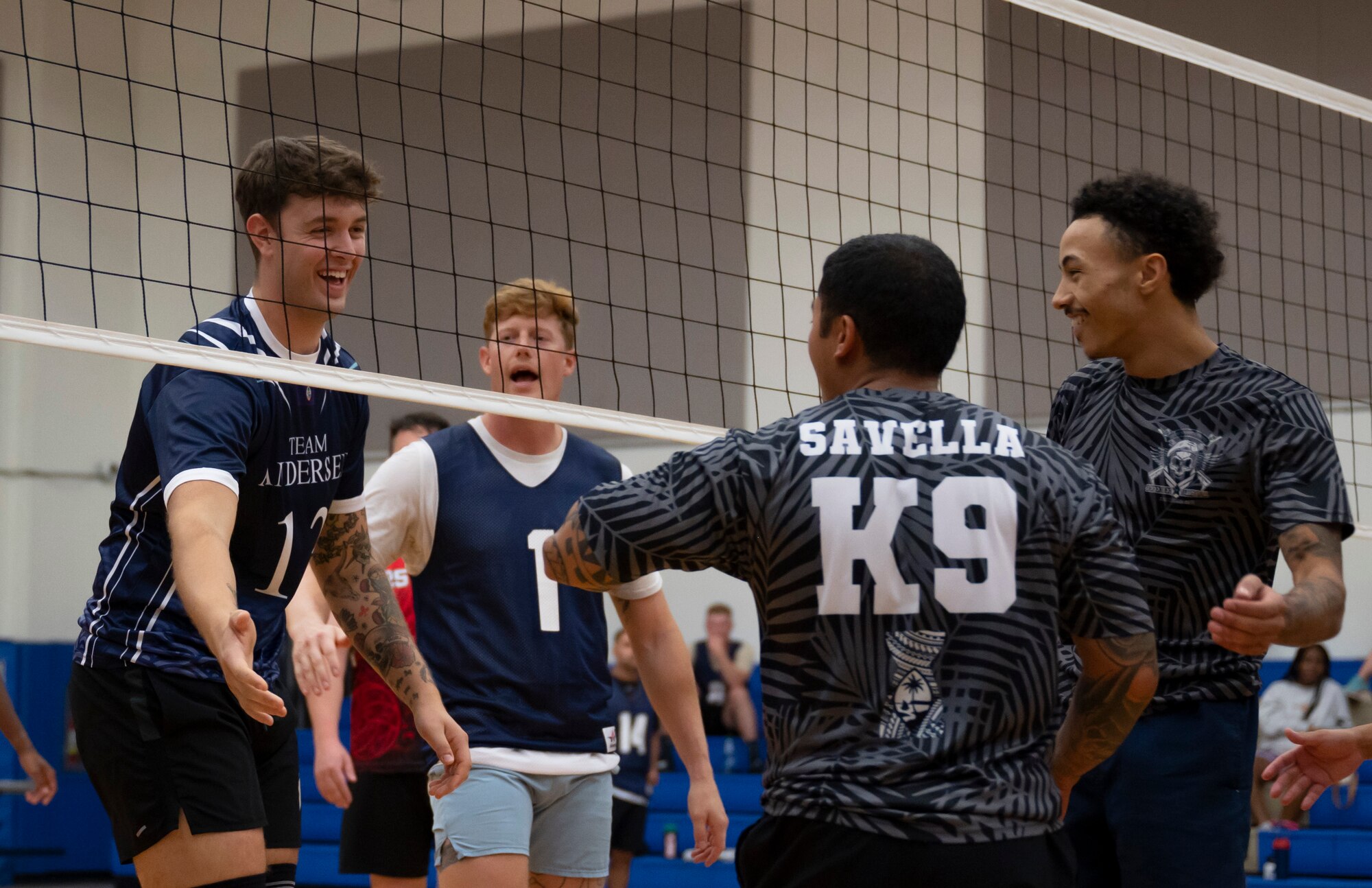 Members of the Civil Engineer Squadron and Security Forces Squadron intramural volleyball teams congratulate each other during the championship game on Andersen Air Force Base, Guam, Oct. 26, 2023.  Andersen’s intramural volleyball league ended in a climactic final game between the Security Forces Squadron and CES. The game ended with SFS being named the champions. (U.S. Air Force photo by Airman 1st Class Spencer Perkins)