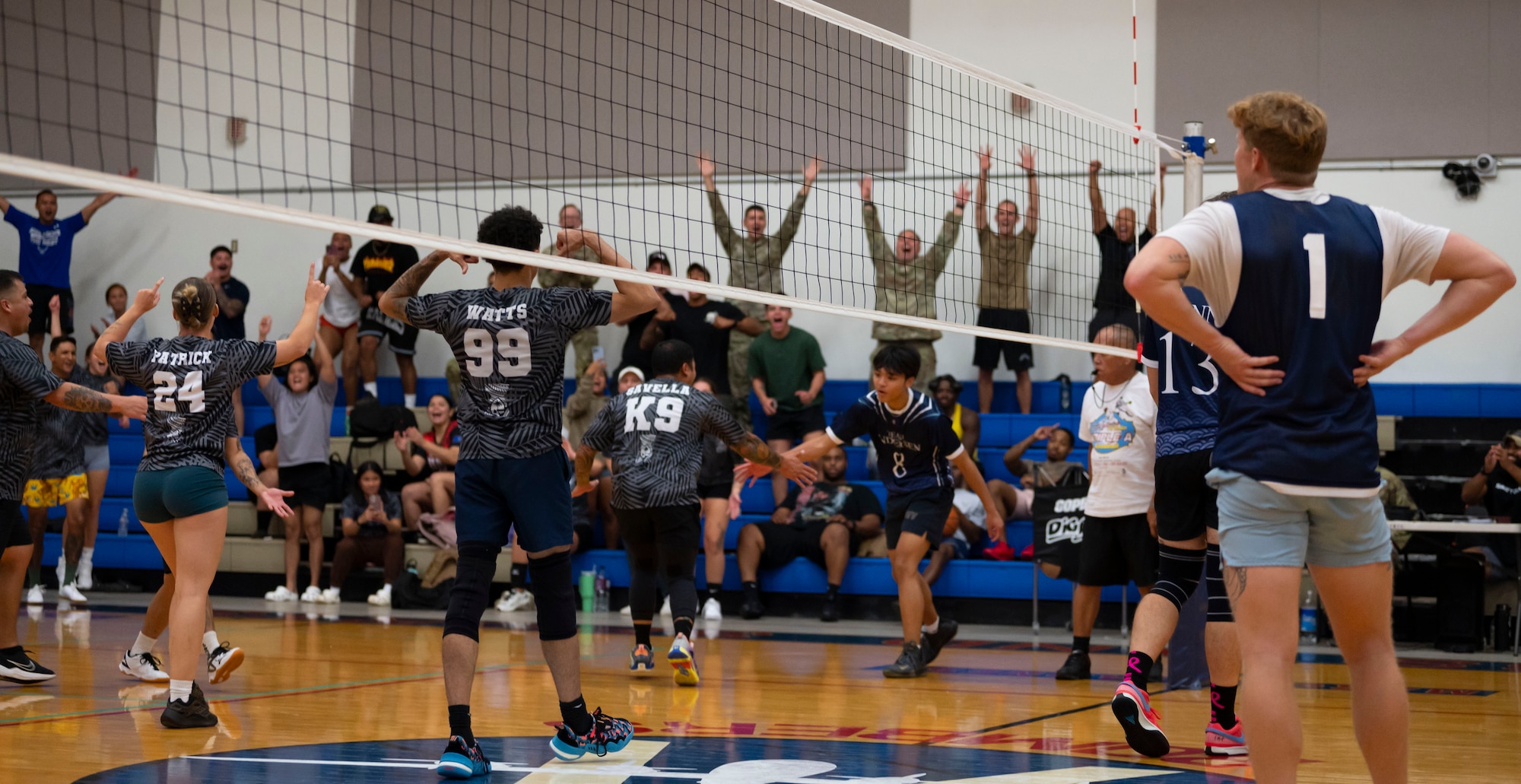 Members of the Security Forces Squadron’s intramural volleyball team celebrate during the championship game on Andersen Air Force Base, Guam, Oct. 26, 2023. Andersen’s intramural volleyball league ended in a climactic final game between the Security Forces Squadron and CES. The game ended with SFS being named the champions. (U.S. Air Force photo by Airman 1st Class Spencer Perkins)