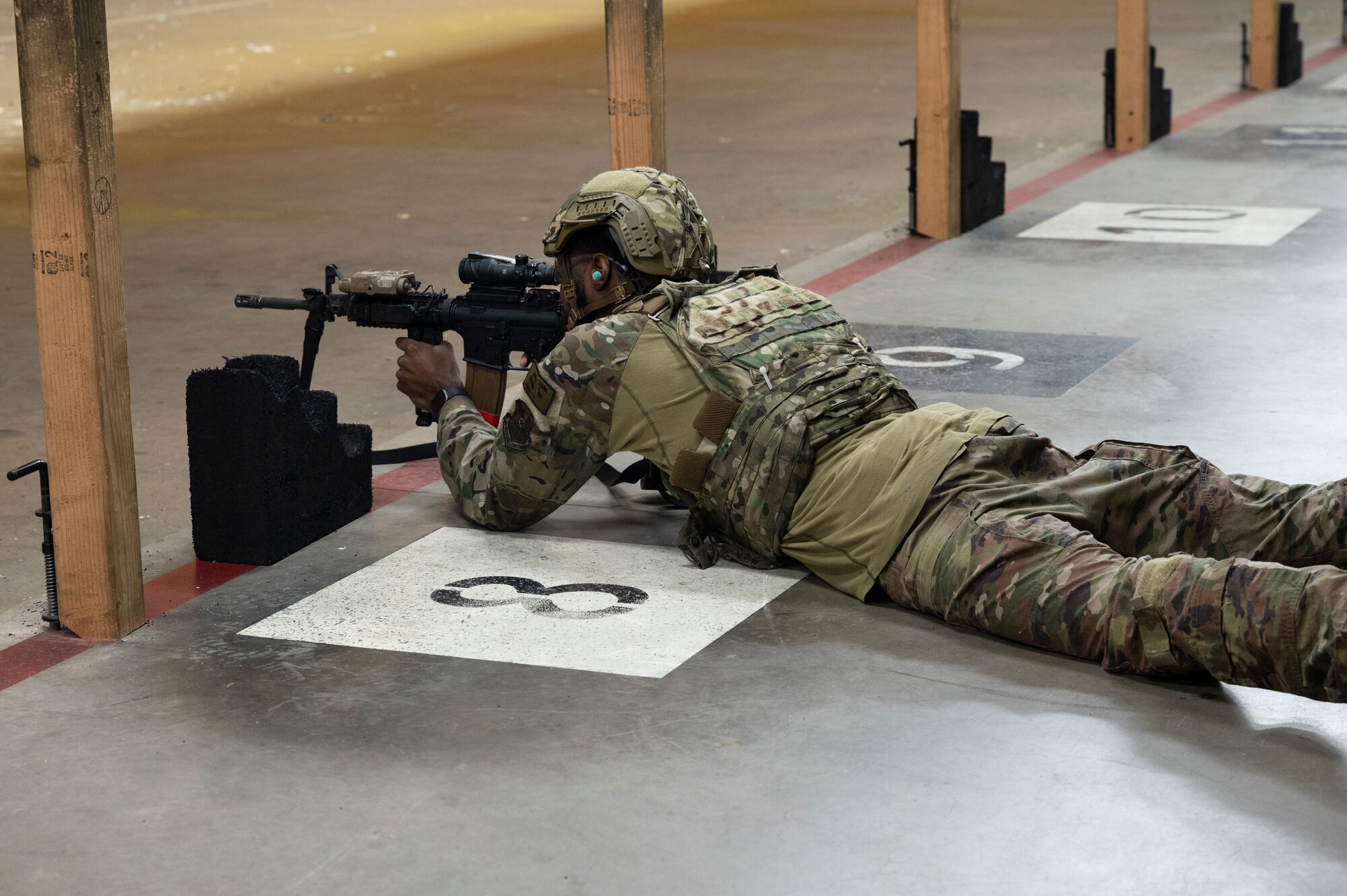 U.S. Air Force Airman 1st Class, Elijah Pogue, 7th Security Forces Squadron defender, fires an M-4 rifle during the combat arms portion of the Expert Defender competition at Dyess Air Force Base, Texas, Oct. 25, 2023. The various portions of the competition pushed Airmen to improve their weapon handling, physical fitness and map reading skills. (U.S. Air Force photo by Airman 1st Class Alondra Cristobal Hernandez)
