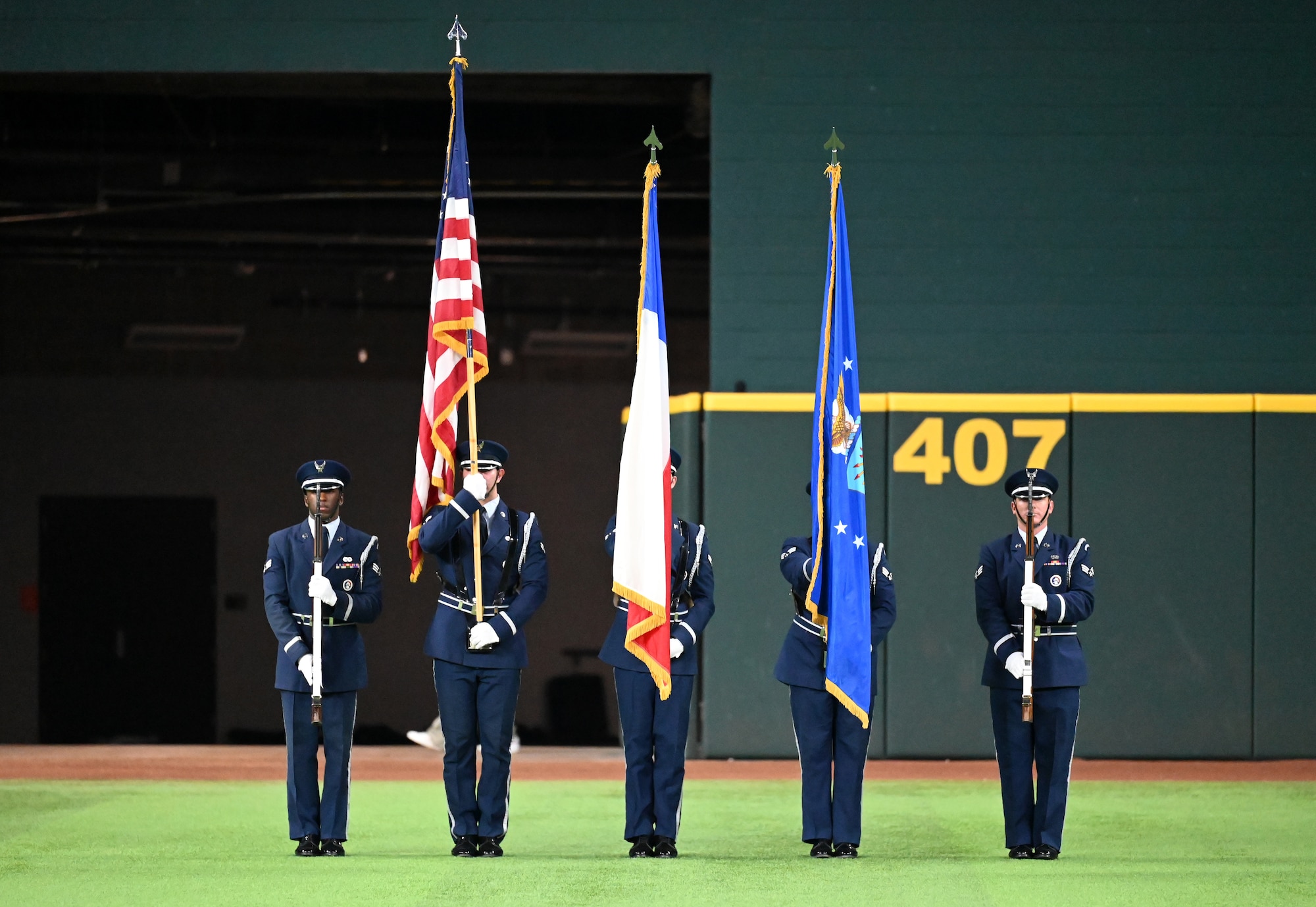 The Dyess Honor Guard presents the colors during the national anthem at the World Series opening game at Globe Life Field in Arlington, Texas, Oct. 27, 2023. The Dyess Honor Guard provides services including funeral honors and presenting the colors at ceremonies, parades and sporting events. (U.S. Air Force photo by Staff Sgt. Holly Cook)